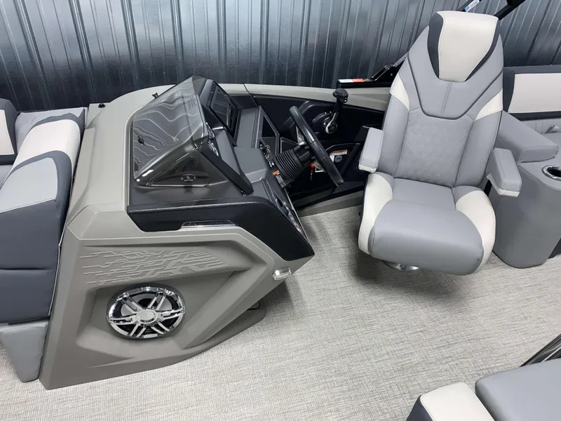 Slide: The Image of 2025 Avalon Catalina 2385 QLS Tritoon interior with modern helm and captain's chair. - 9