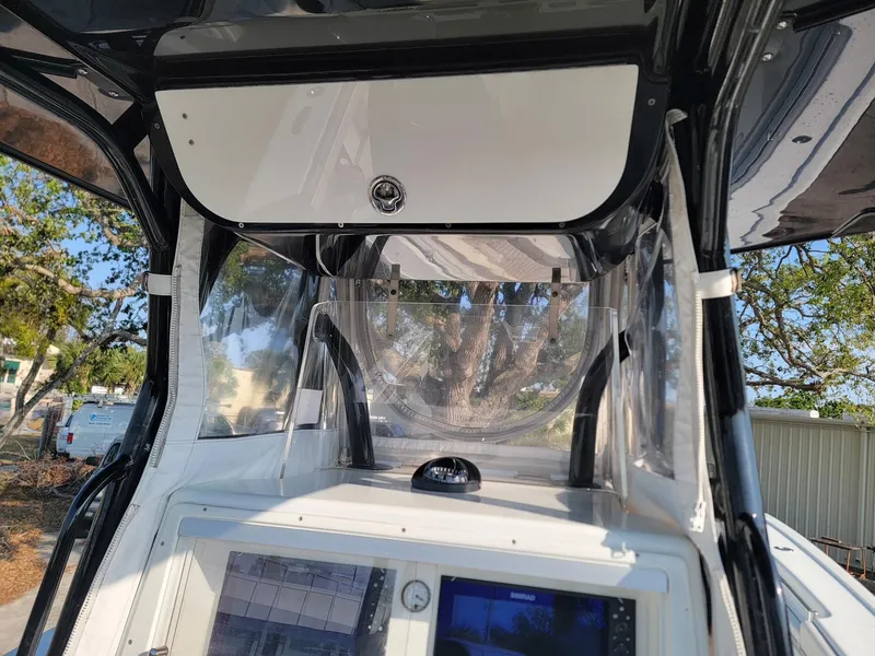 Slide: The Image of 2014 Yellowfin 36 boat console with navigation equipment and protective cover. - 12