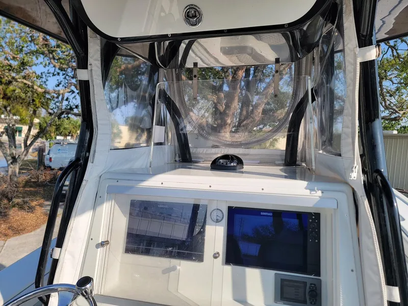 Slide: The Image of 2014 Yellowfin 36 boat dashboard with navigation screens and controls. - 13