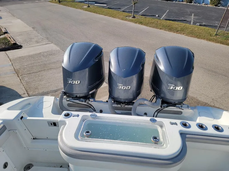 Slide: The Image of 2014 Yellowfin 36 boat with triple 300 horsepower engines, docked on a sunny day. - 17