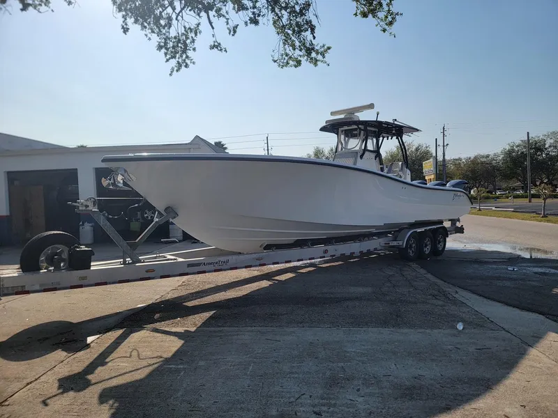 Slide: The Image of 2014 Yellowfin 36 boat on trailer, parked outdoors under clear sky. - 4