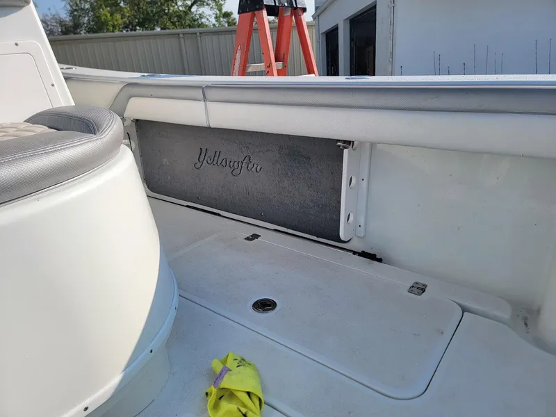 Slide: The Image of 2014 Yellowfin 36 boat interior with storage compartment and cleaning cloth. - 8