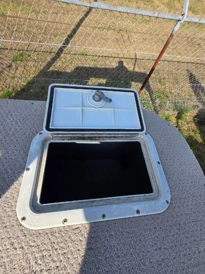 Slide: The Image of Open storage compartment on 2004 SunCatcher g3 22c boat, outdoor setting. - 13