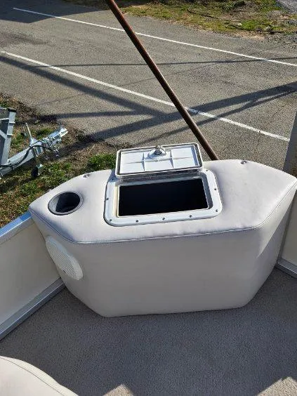 Slide: The Image of 2004 SunCatcher G3 22C boat interior with storage compartment and cup holder. - 14