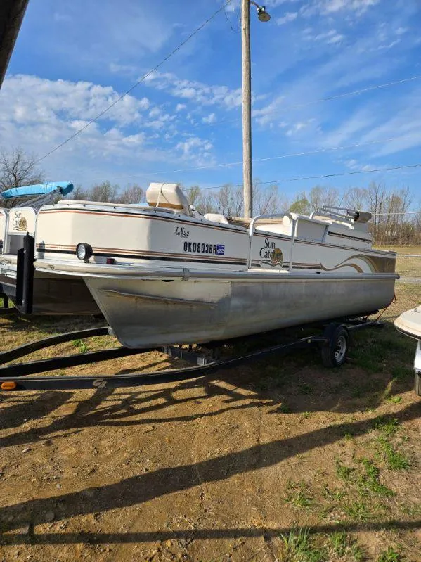 Slide: The Image of 2004 SunCatcher G3 22C pontoon boat on trailer under a clear blue sky. - 3