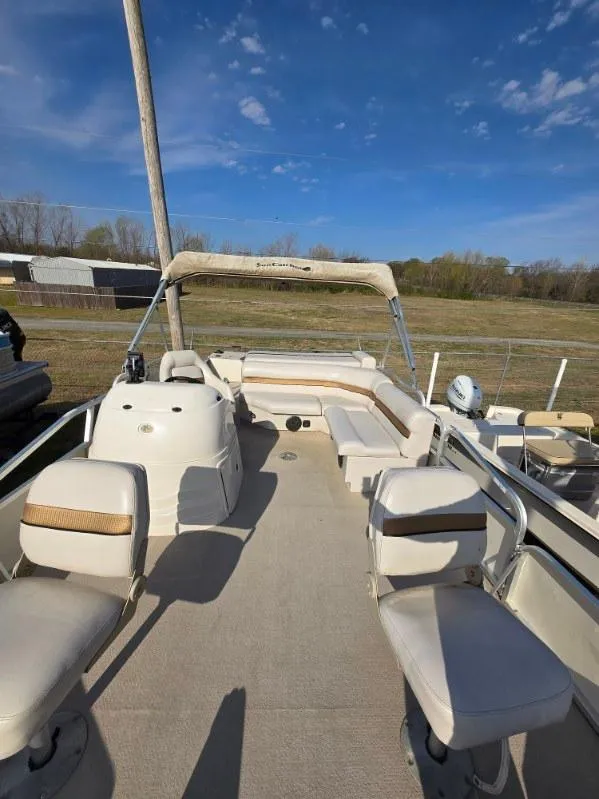 Slide: The Image of 2004 SunCatcher G3 22C pontoon boat with spacious seating under a clear blue sky. - 9