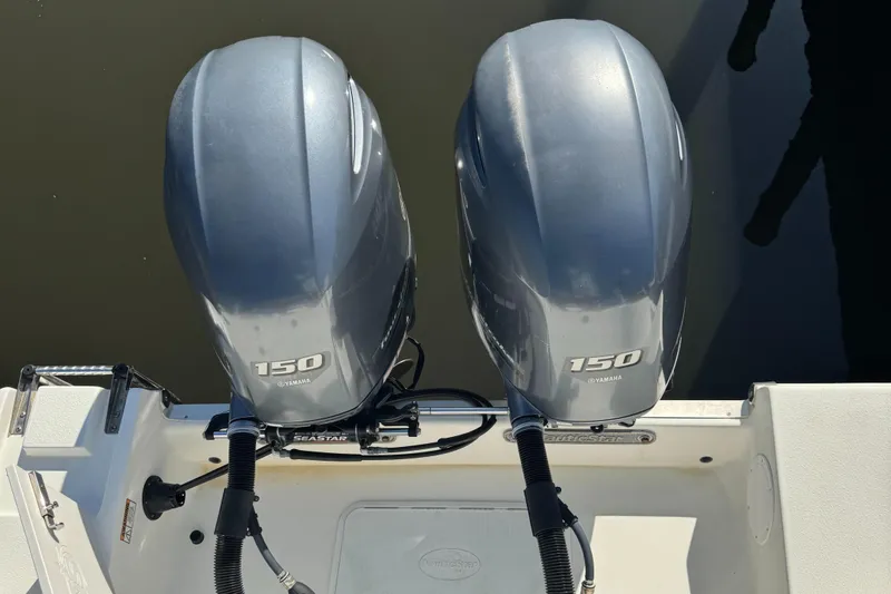 Slide: The Image of Twin 150 horsepower engines on a 2019 NauticStar 25XS boat, viewed from above. - 13