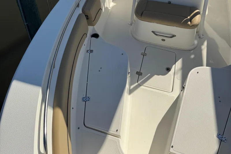 Slide: The Image of 2019 NauticStar 25XS boat interior with seating and storage compartments. - 6