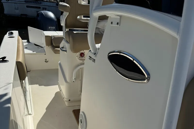 Slide: The Image of 2019 NauticStar 25XS boat interior with seating and console details. - 7