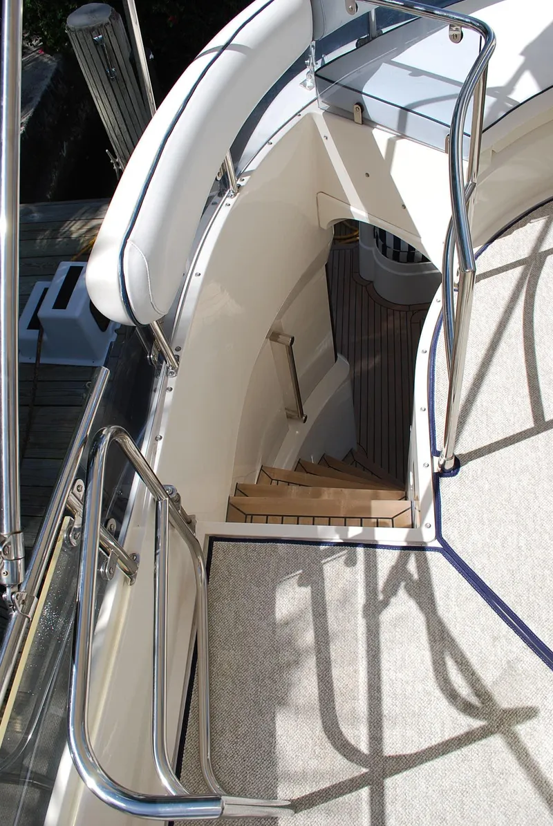 Slide: The Image of Staircase on 2000 Fairline Squadron yacht, featuring sleek design and stainless steel railings. - 11