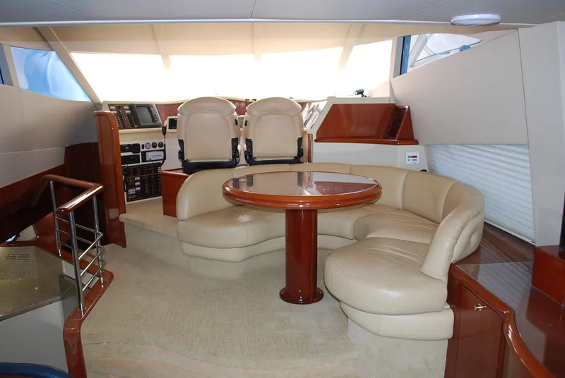 Slide: The Image of Luxurious interior of a 2000 Fairline Squadron yacht with plush seating and elegant wood finishes. - 15