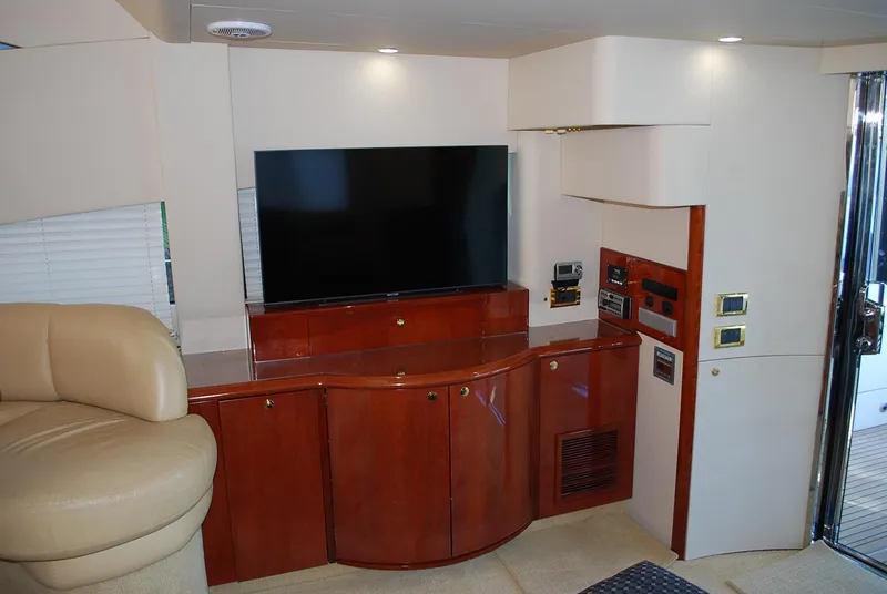 Slide: The Image of Interior of 2000 Fairline Squadron yacht with TV and wooden cabinetry. - 16