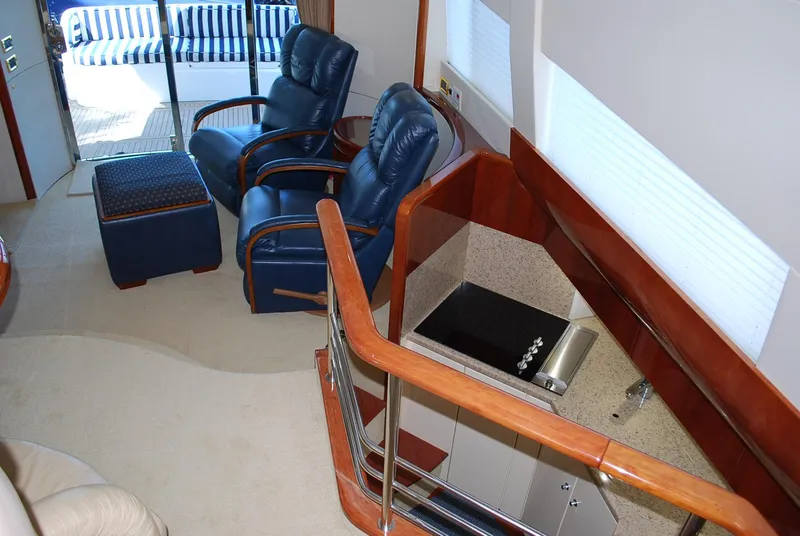 Slide: The Image of Interior of 2000 Fairline Squadron yacht with blue leather chairs and modern kitchenette. - 18