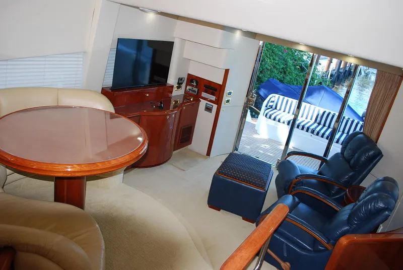 Slide: The Image of Luxurious interior of 2000 Fairline Squadron yacht with elegant seating and dining area. - 19