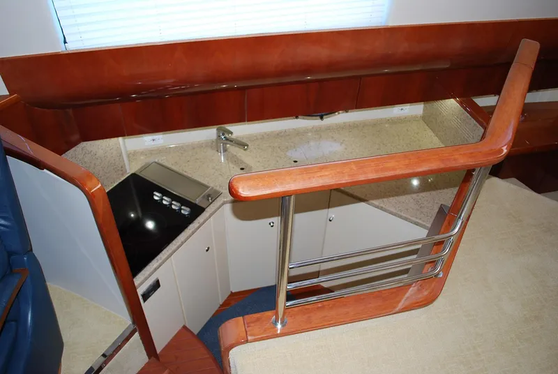 Slide: The Image of Interior of 2000 Fairline Squadron yacht, featuring a compact kitchen with modern amenities. - 20