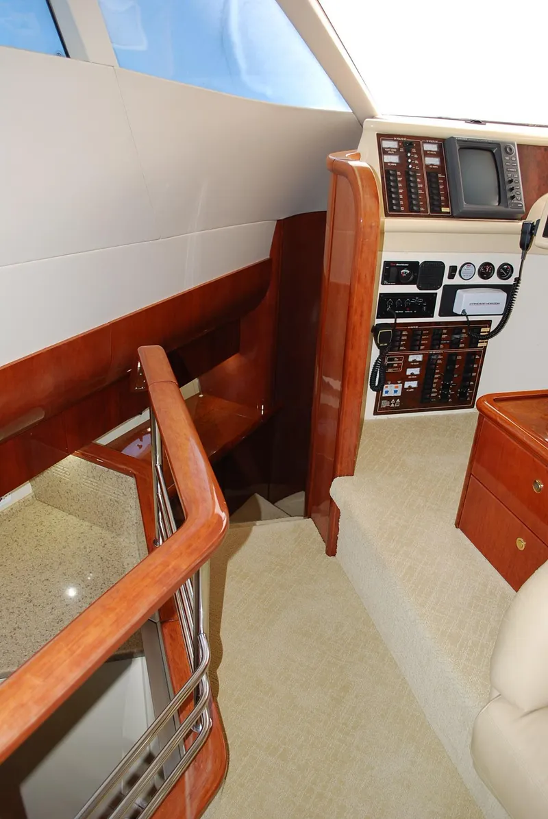 Slide: The Image of Interior of 2000 Fairline Squadron yacht with control panel and wooden finishes. - 21