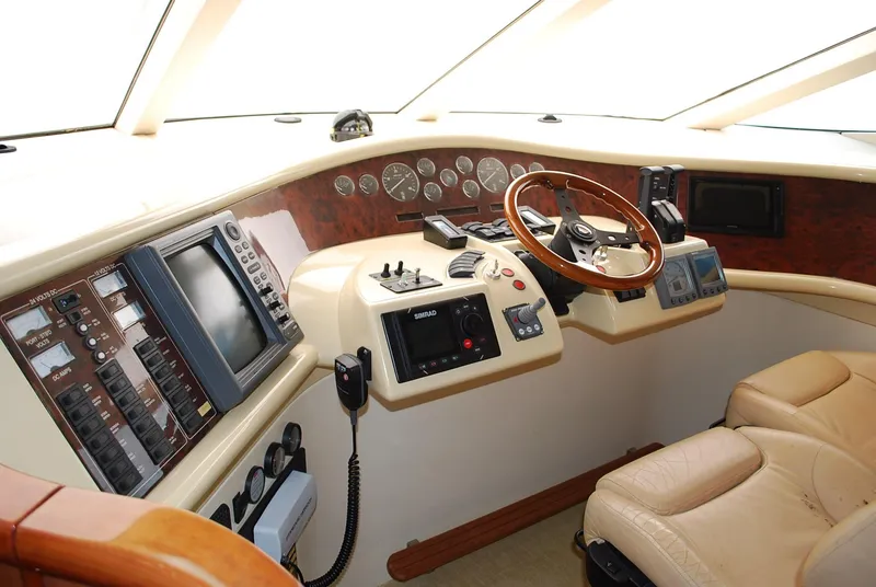 Slide: The Image of Helm of 2000 Fairline Squadron yacht with navigation instruments and leather seating. - 23
