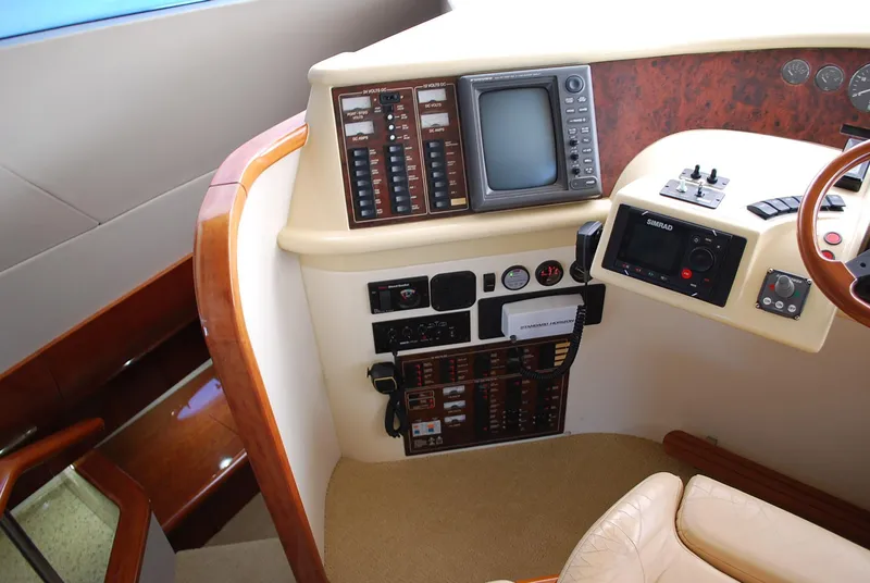 Slide: The Image of Control panel of a 2000 Fairline Squadron yacht, featuring navigation and communication equipment. - 24