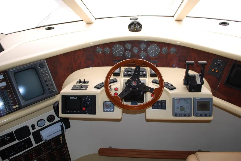 Slide: The Image of Cockpit of 2000 Fairline Squadron yacht with steering wheel and navigation instruments. - 25