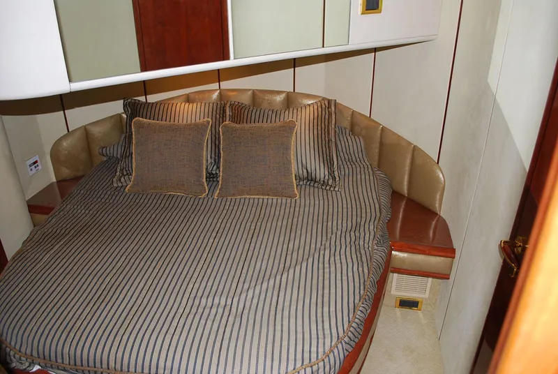 Slide: The Image of Luxurious cabin interior of 2000 Fairline Squadron yacht with striped bedding and cushions. - 31