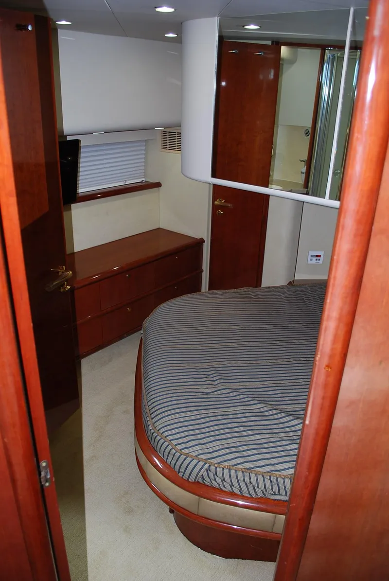 Slide: The Image of Luxurious cabin interior of 2000 Fairline Squadron yacht with wood finishes and striped bedding. - 32