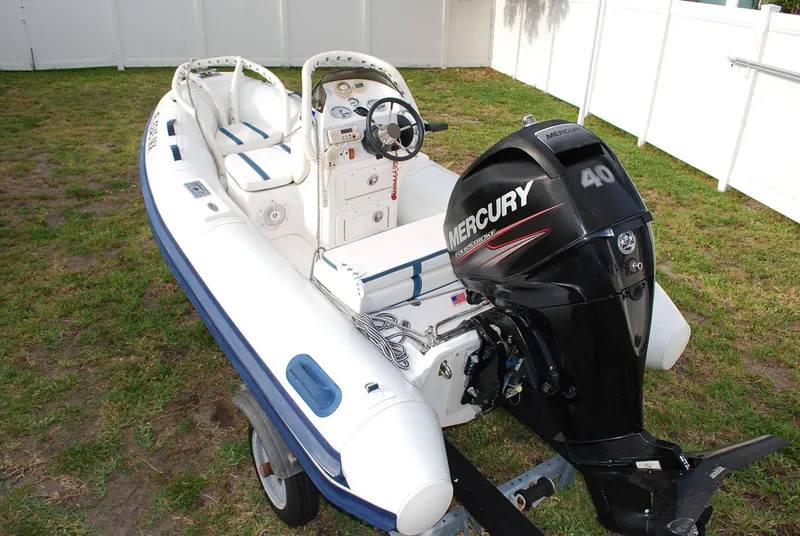 Slide: The Image of A Fairline Squadron 2000 boat with a Mercury 40 outboard motor on a trailer. - 40
