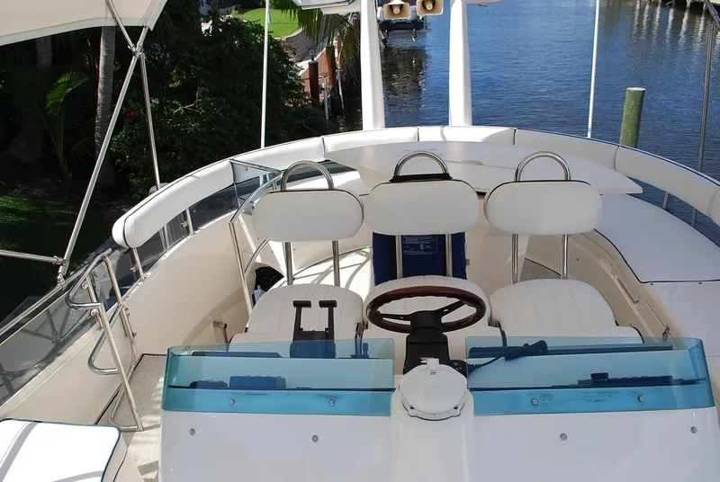 Slide: The Image of Cockpit of 2000 Fairline Squadron yacht with steering wheel and controls, overlooking waterway. - 7