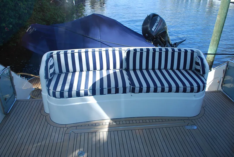 Slide: The Image of Striped seating on 2000 Fairline Squadron yacht deck, near water. - 8