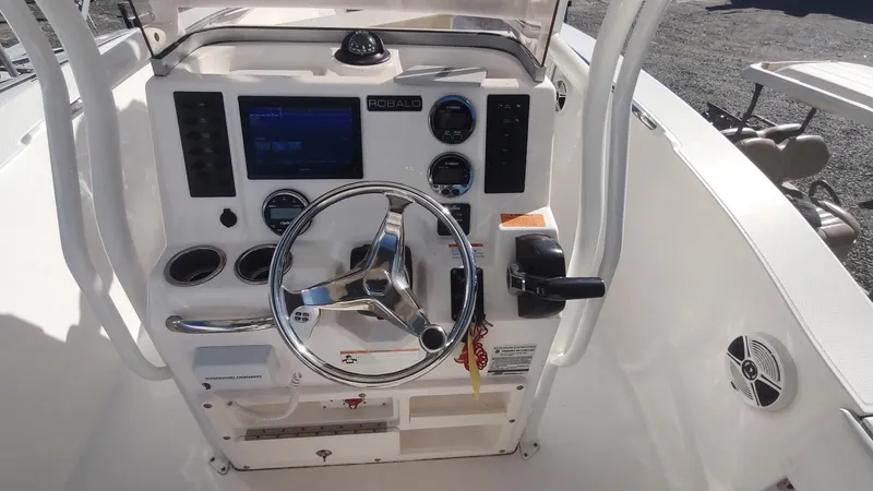 Slide: The Image of 2018 Robalo R200 Center Console boat dashboard with steering wheel and controls. - 4