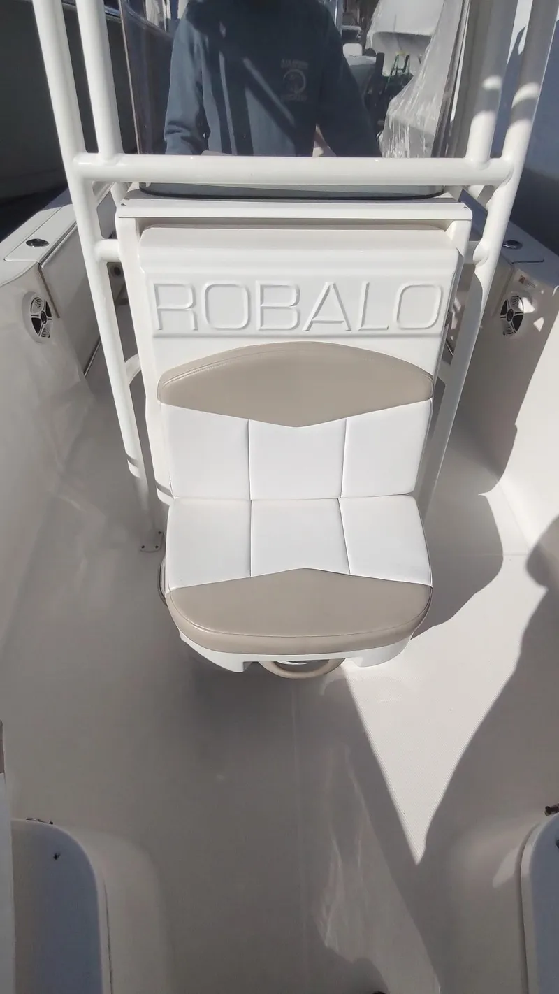 Slide: The Image of 2018 Robalo R200 Center Console boat seat with white and beige upholstery. - 6