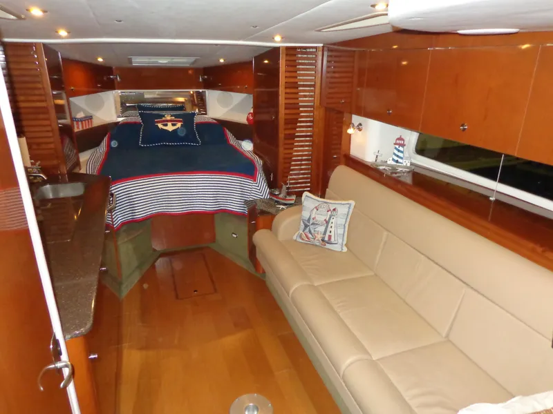 Slide: The Image of Interior of 2014 Sea Ray 370 Sundancer with cozy seating and nautical decor. - 1