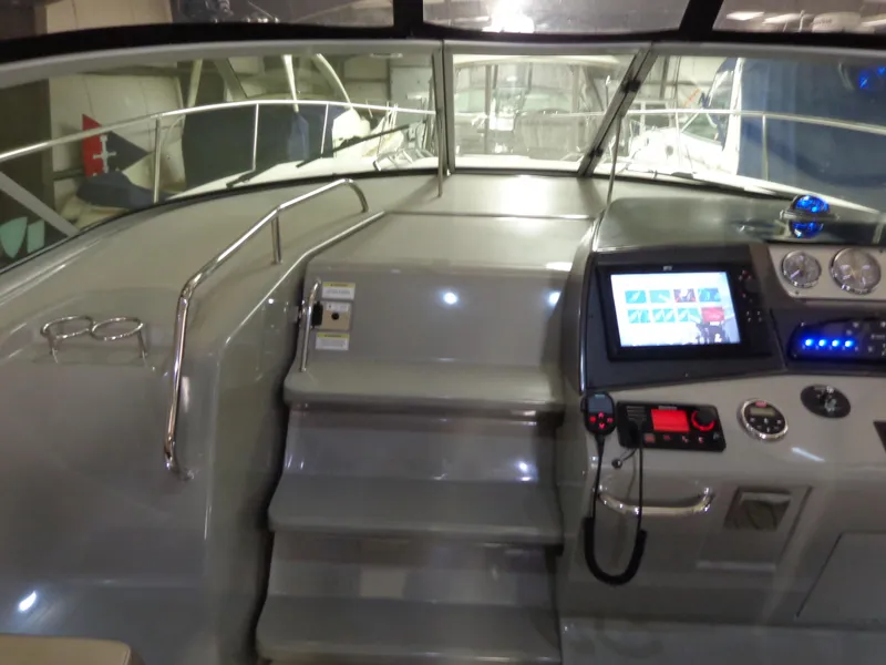 Slide: The Image of 2014 Sea Ray 370 Sundancer helm with modern controls and navigation system. - 11