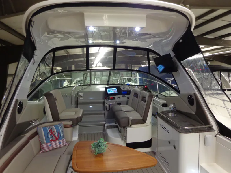 Slide: The Image of Interior of 2014 Sea Ray 370 Sundancer yacht with seating and control panel. - 16