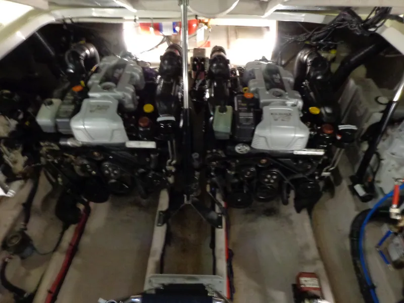 Slide: The Image of Engine compartment of 2014 Sea Ray 370 Sundancer with dual engines and mechanical components. - 20