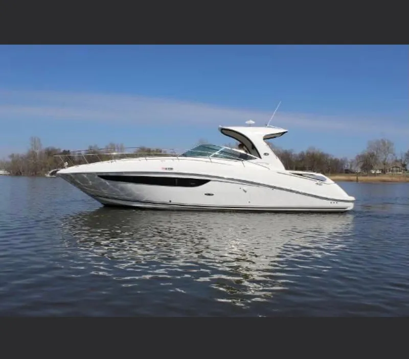 Slide: The Image of 2014 Sea Ray 370 Sundancer yacht on calm water under clear blue sky. - 21