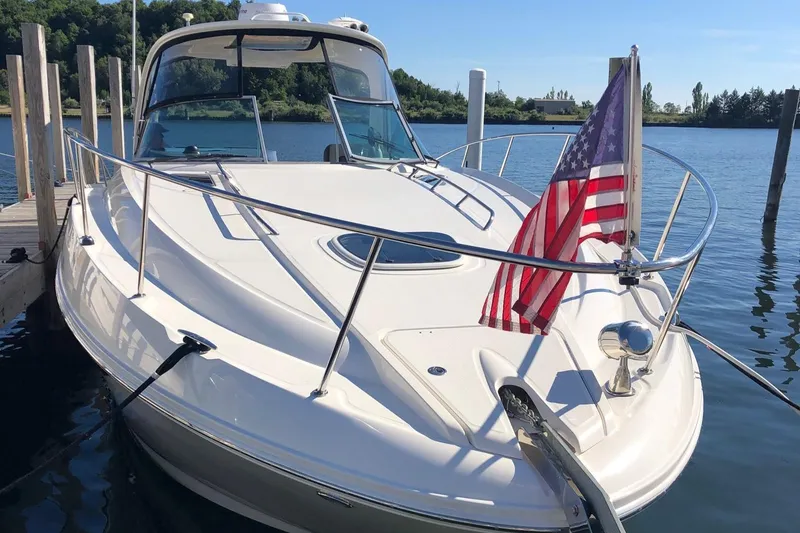 Slide: The Image of 2014 Sea Ray 370 Sundancer docked with American flag, sunny day. - 26