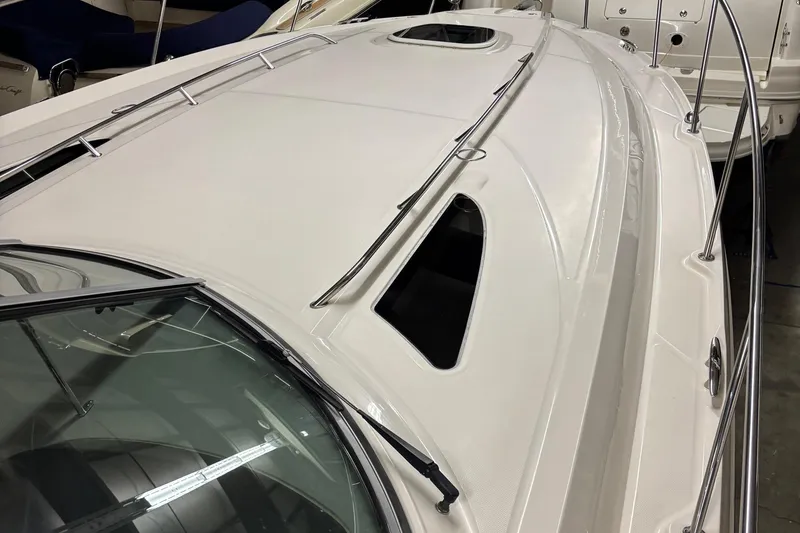 Slide: The Image of 2014 Sea Ray 370 Sundancer boat deck with sleek design and stainless steel railings. - 27