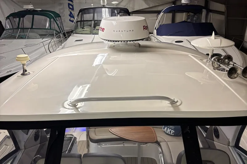 Slide: The Image of 2014 Sea Ray 370 Sundancer yacht with radar, docked indoors. - 28