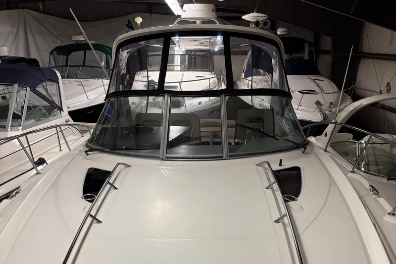 Slide: The Image of 2014 Sea Ray 370 Sundancer yacht in storage, front view with multiple boats nearby. - 30