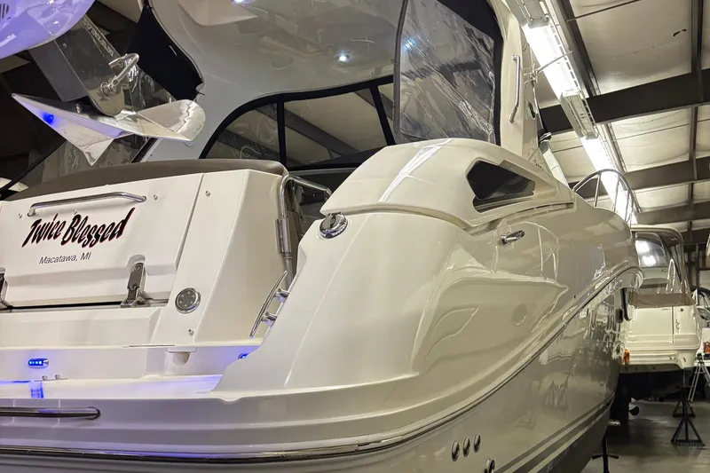 Slide: The Image of 2014 Sea Ray 370 Sundancer yacht in a well-lit indoor storage facility. - 34