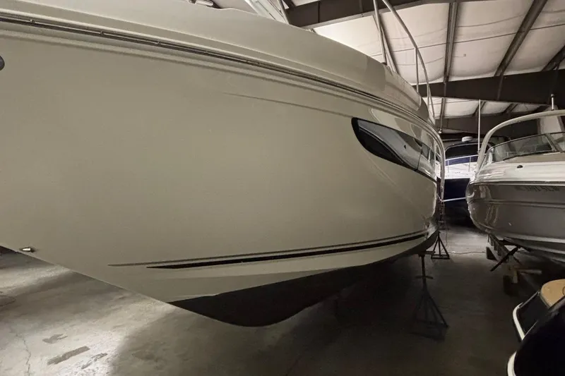 Slide: The Image of 2014 Sea Ray 370 Sundancer boat in indoor storage facility. - 35