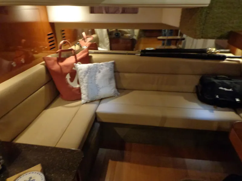 Slide: The Image of Interior of 2014 Sea Ray 370 Sundancer with beige seating and decorative pillows. - 4