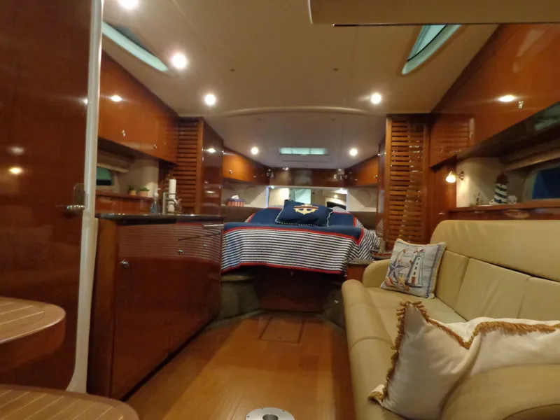 Slide: The Image of Interior of 2014 Sea Ray 370 Sundancer yacht with cozy seating and elegant wood finishes. - 6