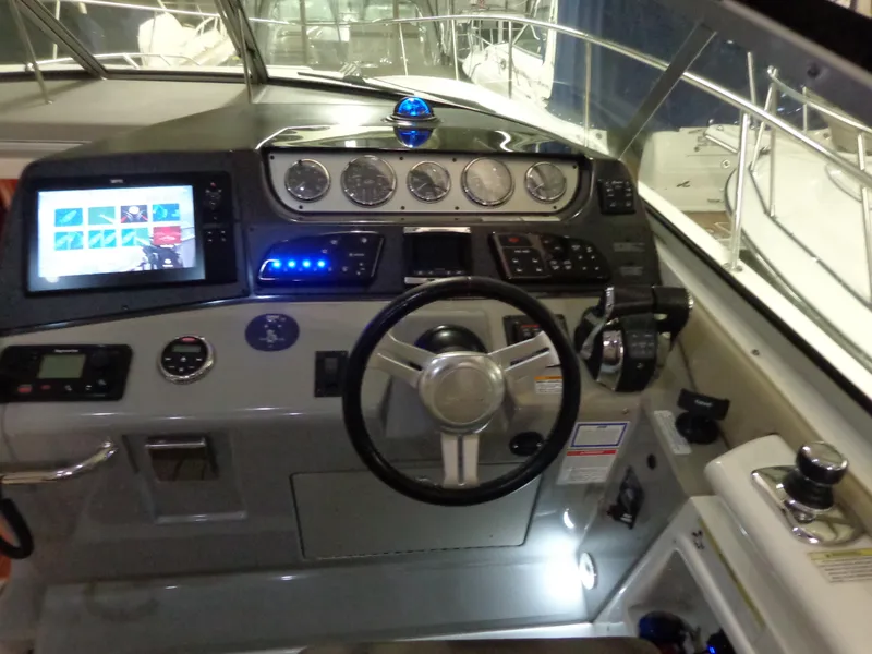 Slide: The Image of Cockpit of 2014 Sea Ray 370 Sundancer with modern controls and navigation display. - 7