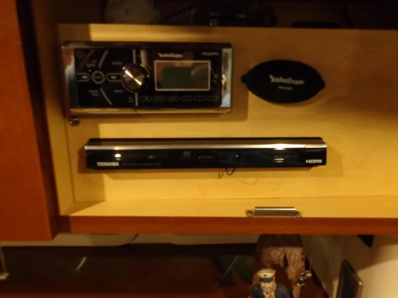 Slide: The Image of Audio and video equipment inside a 2014 Sea Ray 370 Sundancer boat cabinet. - 8
