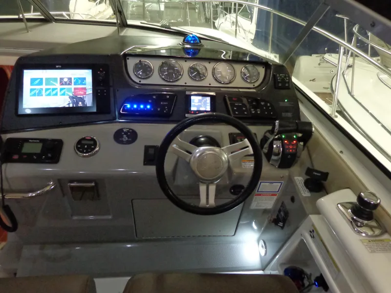 Slide: The Image of Helm of 2014 Sea Ray 370 Sundancer with modern navigation controls and displays. - 9