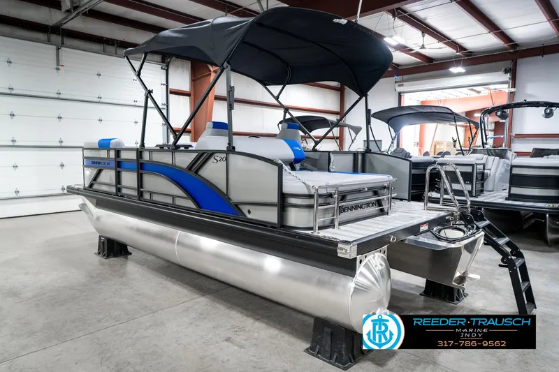Slide: The Image of 2025 Bennington 20 SSB pontoon boat in showroom with canopy and modern design. - 10