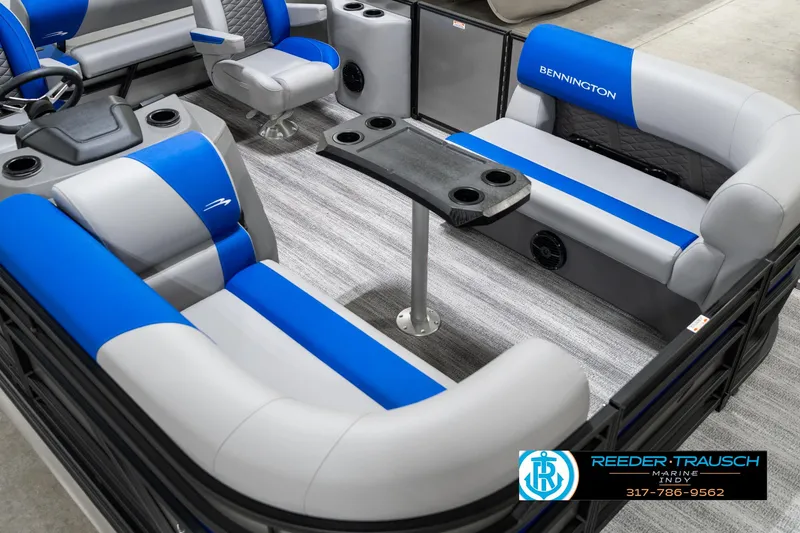 Slide: The Image of 2025 Bennington 20 SSB pontoon boat interior with blue and gray seating and table. - 13
