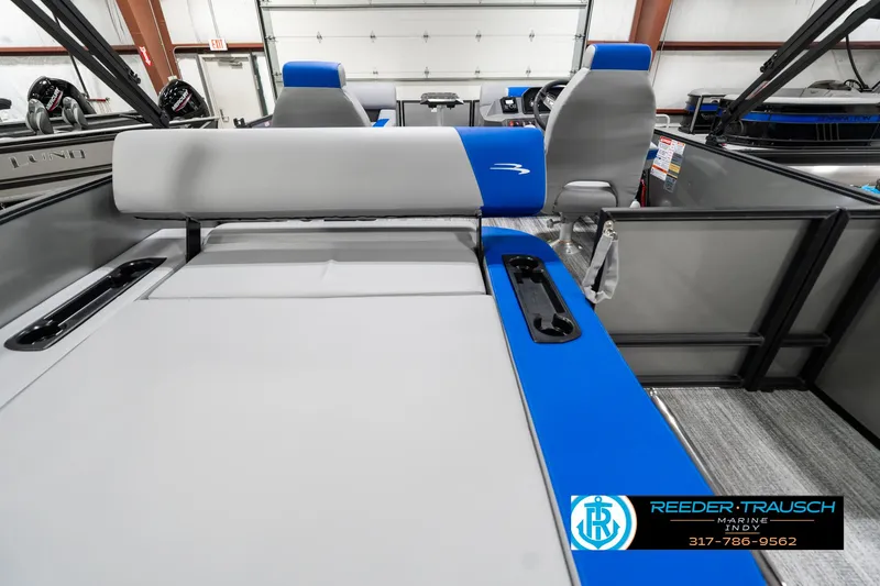 Slide: The Image of 2025 Bennington 20 SSB boat interior with gray and blue seating, showcased by Reeder-Trausch Marine. - 19