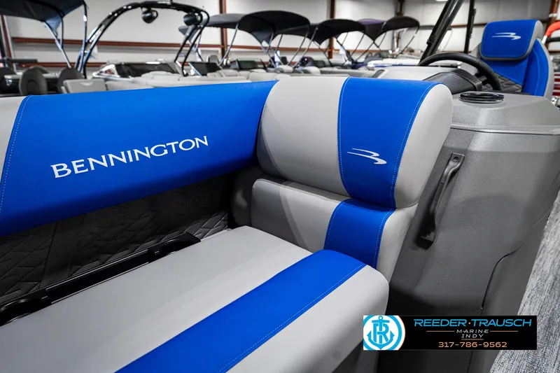 Slide: The Image of 2025 Bennington 20 SSB boat interior with blue and gray seating, Reeder-Trausch Marine logo. - 40